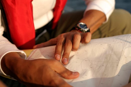 Close-up of a man pointing at a map, highlighting navigation and exploration.